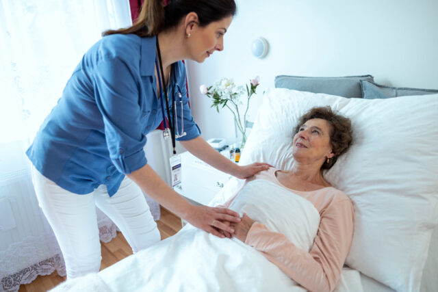 Nurse helping elderly patient