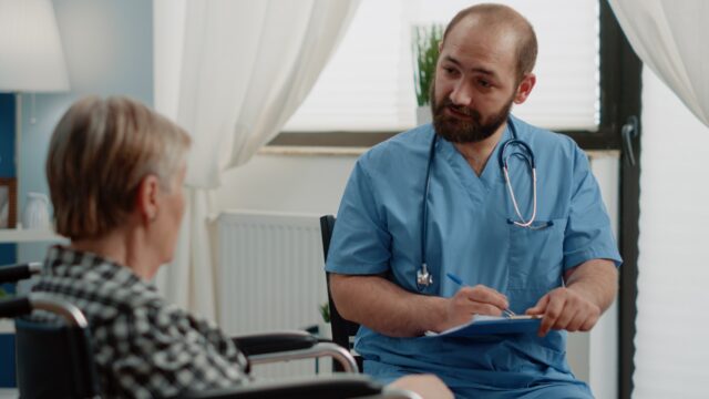 Patient talking to nurse.